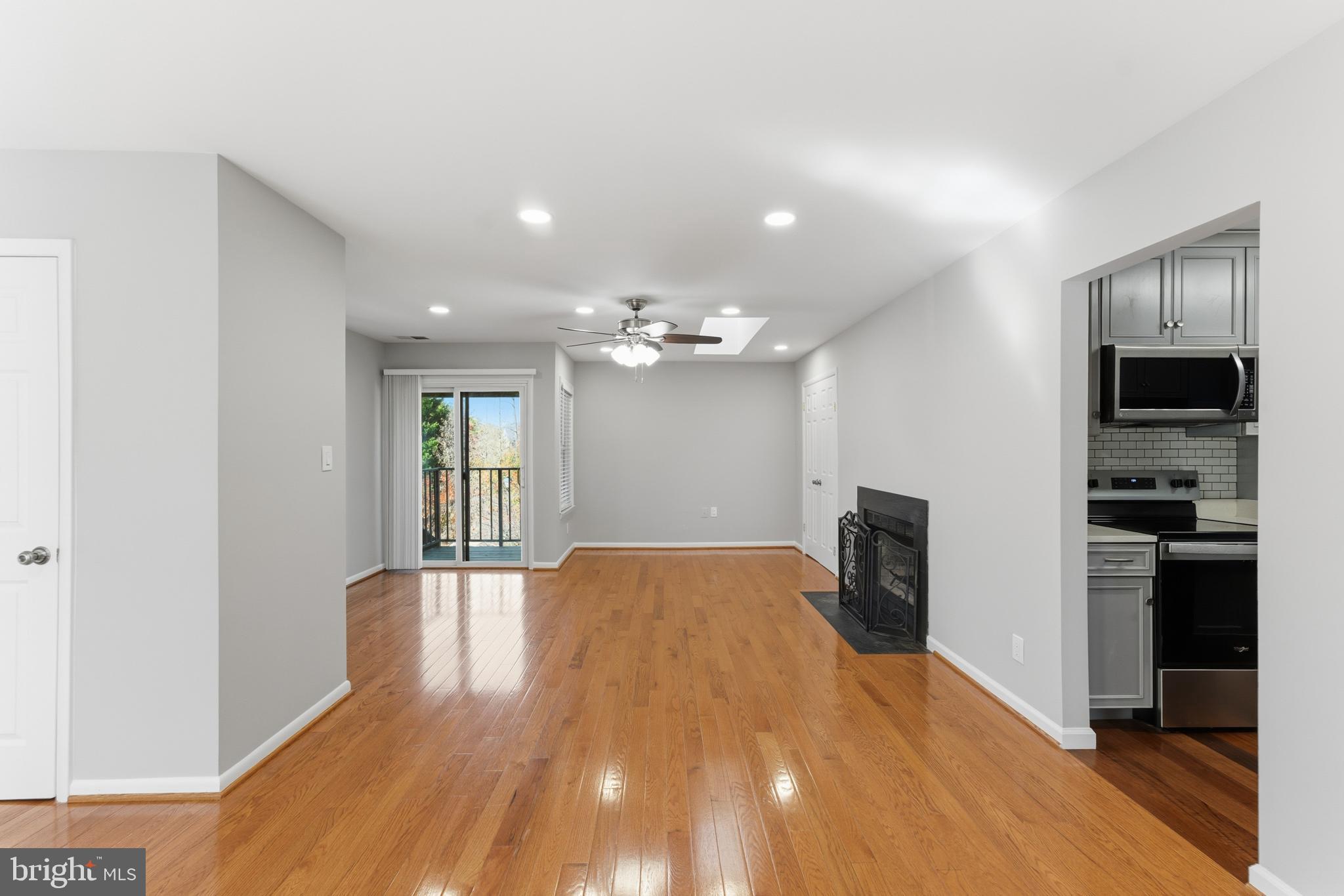 13406 Shady Knoll Drive, Unit 305 Silver Spring, MD 20904 - Photo 5 of 37 wooden floor in an empty room with a kitchen