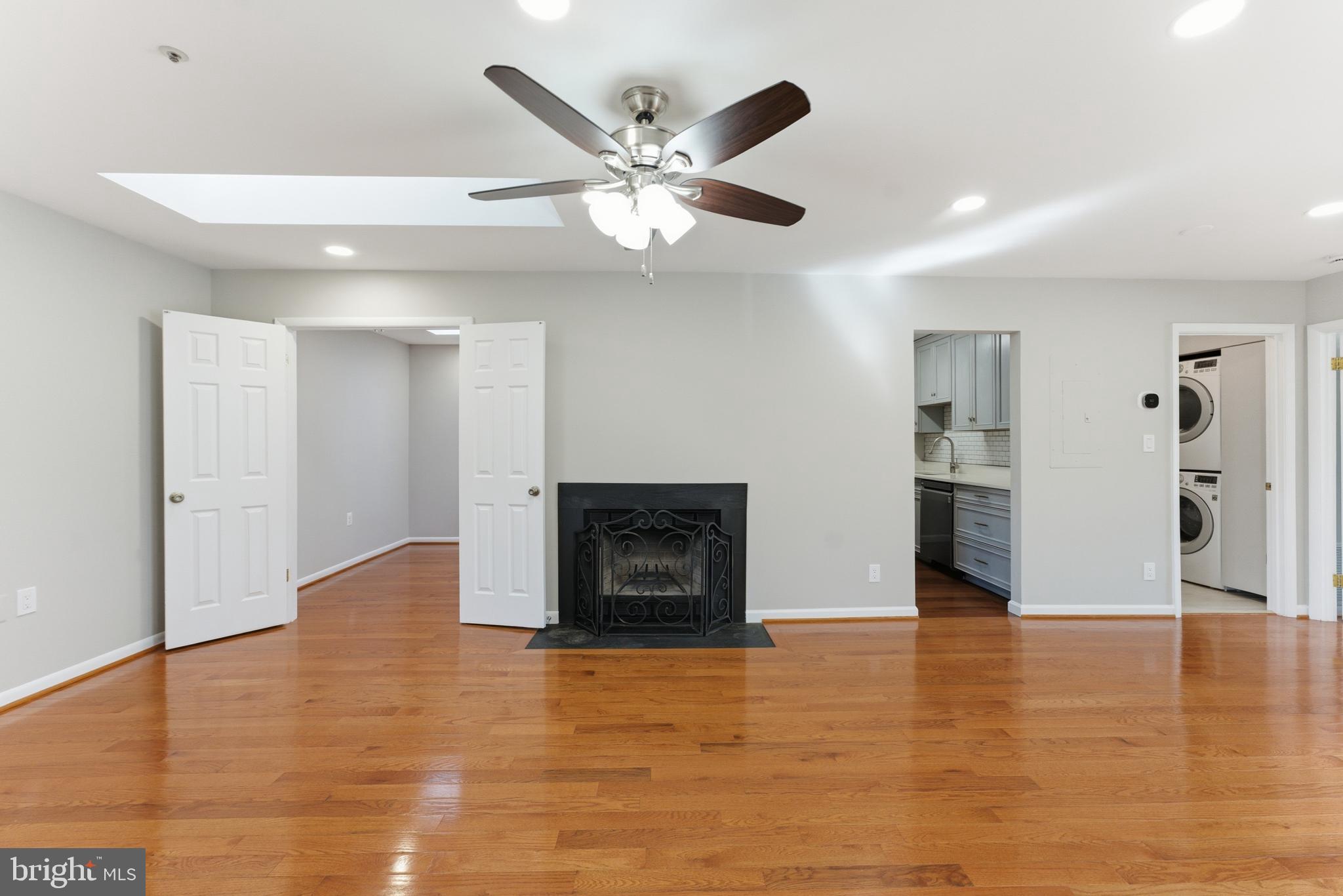 13406 Shady Knoll Drive, Unit 305 Silver Spring, MD 20904 - Photo 8 of 37 a view of an empty room with a fireplace and a window