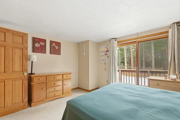 a bedroom with a bed and a large window