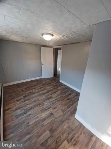 an empty room with wooden floor