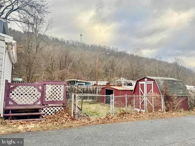 a view of a chairs and table in the back yard