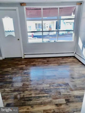 a view of a room with wooden floor