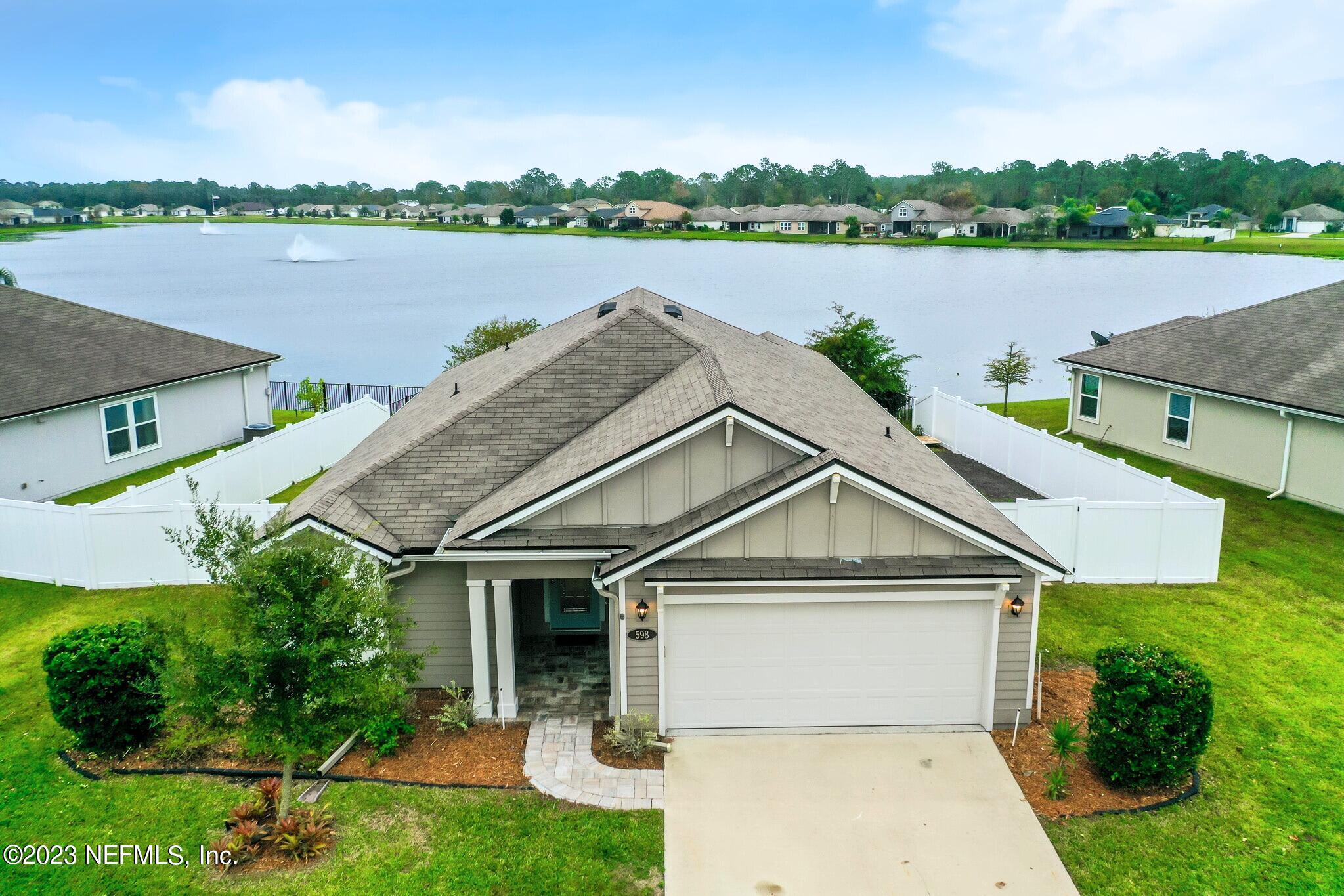 598 Deer Crossing Road St. Augustine, FL 32086 - Photo 1 of 33 a view of a house with a yard and lake view