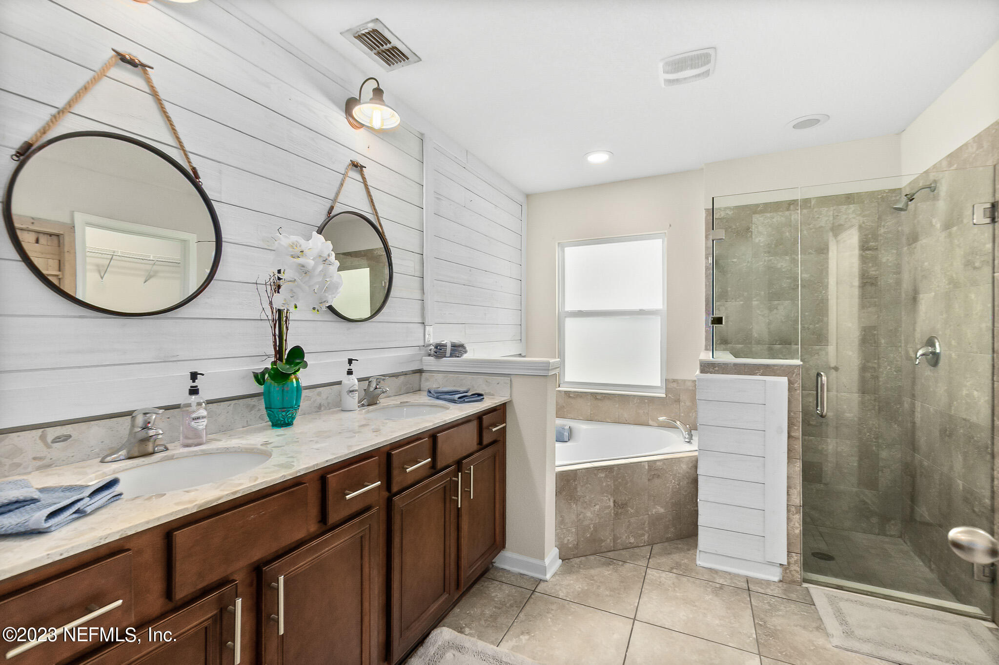 598 Deer Crossing Road St. Augustine, FL 32086 - Photo 18 of 33 a bathroom with a double vanity sink mirror and shower