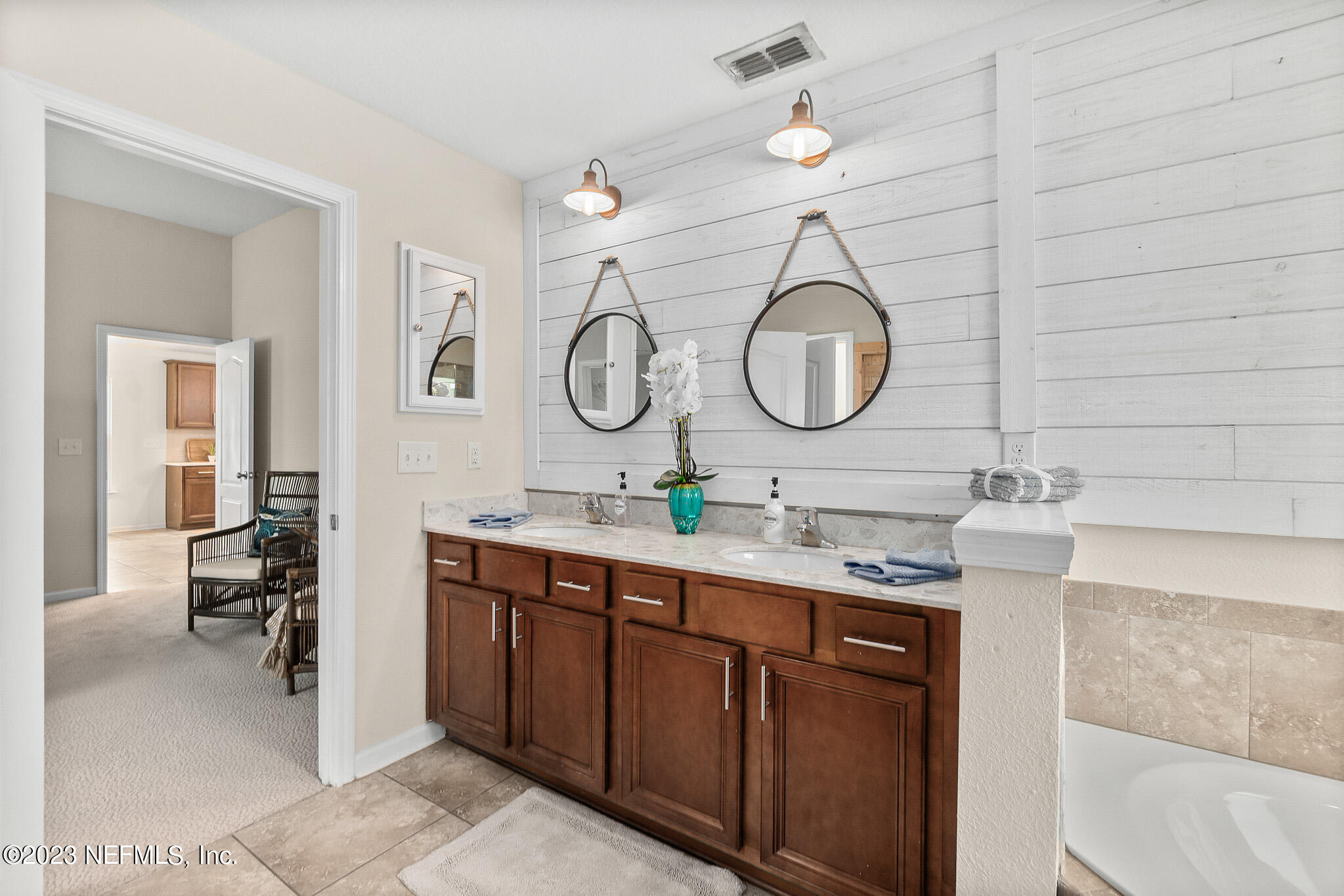 598 Deer Crossing Road St. Augustine, FL 32086 - Photo 20 of 33 a bathroom with a double vanity sink and a mirror