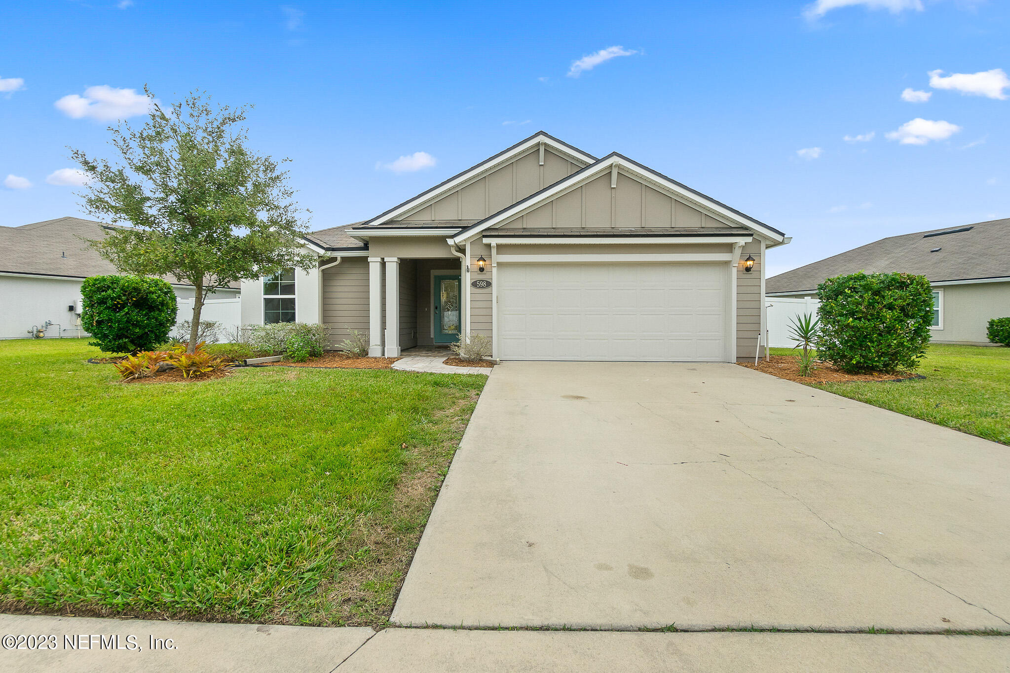 598 Deer Crossing Road St. Augustine, FL 32086 - Photo 2 of 33 a front view of house with yard and garage