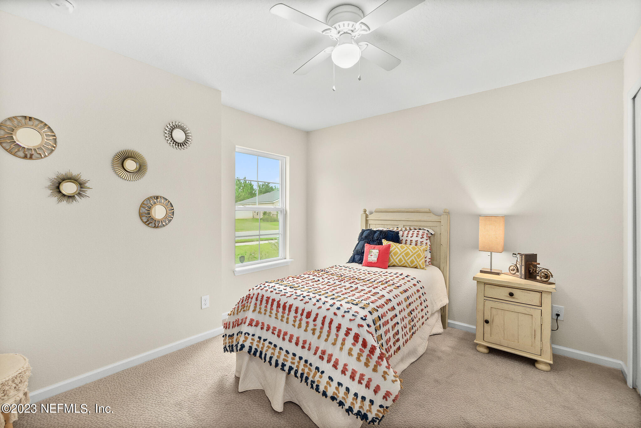 598 Deer Crossing Road St. Augustine, FL 32086 - Photo 21 of 33 a bedroom with a bed and a window