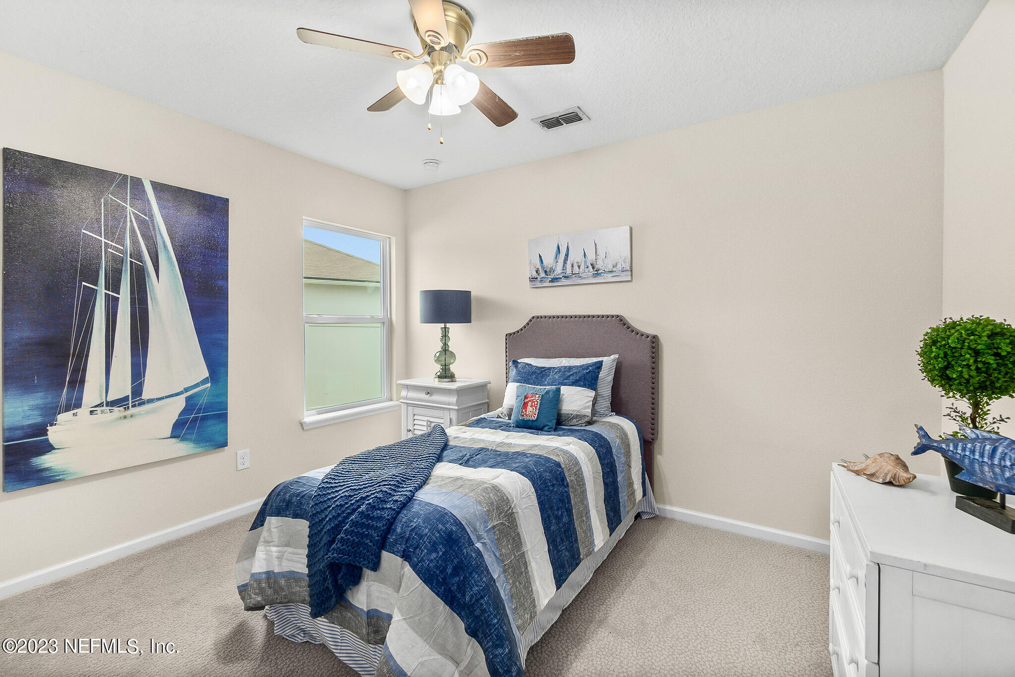 598 Deer Crossing Road St. Augustine, FL 32086 - Photo 23 of 33 a bedroom with a bed and a chandelier