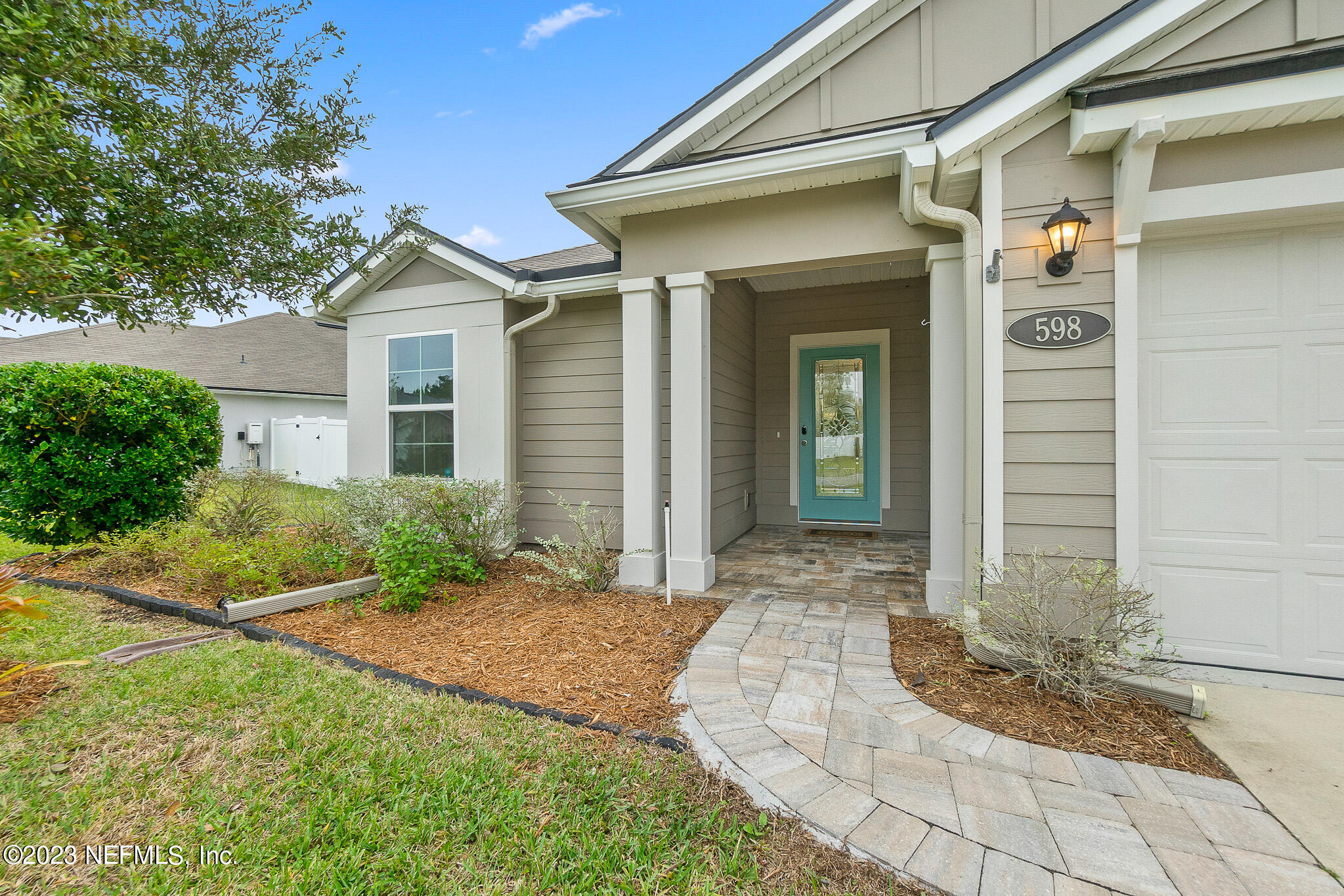 598 Deer Crossing Road St. Augustine, FL 32086 - Photo 4 of 33 a front view of a house with garden