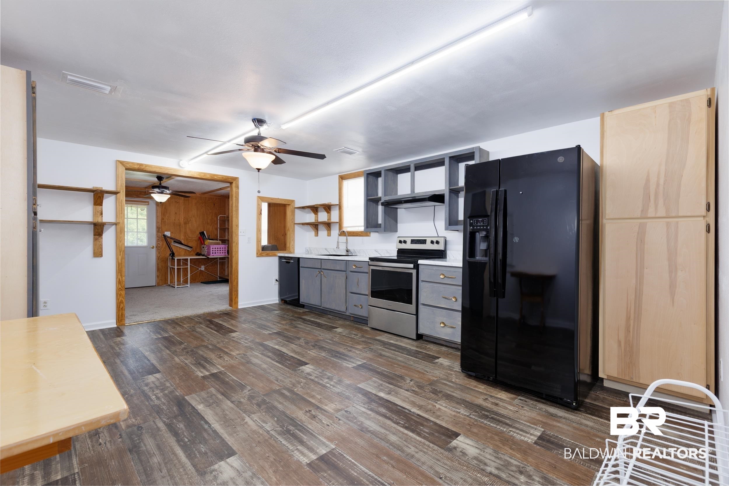6725 Upper Creek Road Flomaton, AL 36441 - Photo 57 of 61 Kitchen featuring black appliances, dark wood-style flooring, exhaust hood, a sink, and ceiling fan
