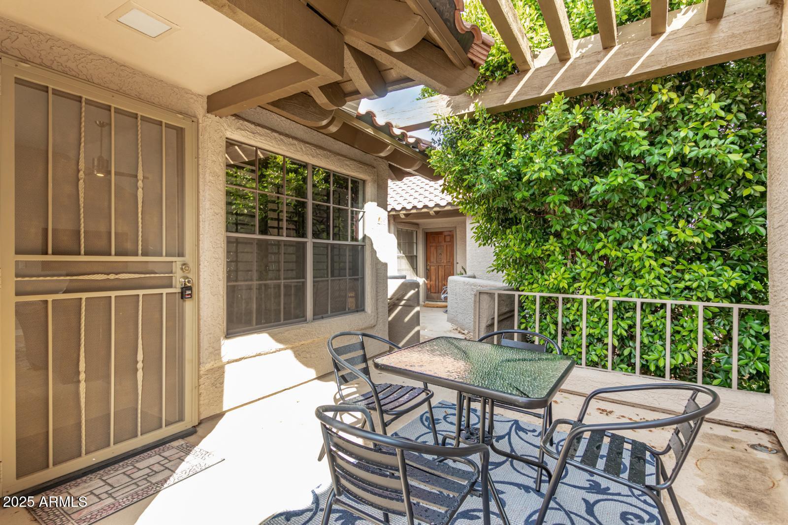 10015 East Mountain View Road, Unit 2017 Scottsdale, AZ 85258 - Photo 12 of 45 a view of a patio with a table and chairs