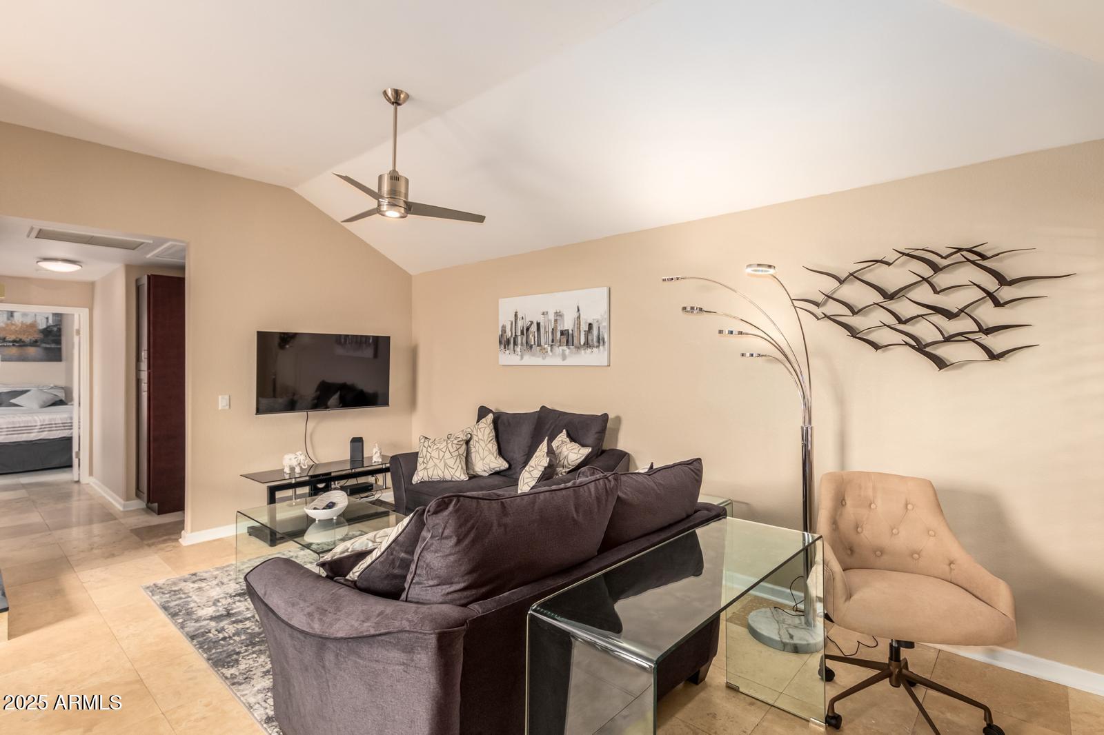 10015 East Mountain View Road, Unit 2017 Scottsdale, AZ 85258 - Photo 2 of 45 a living room with furniture and a flat screen tv