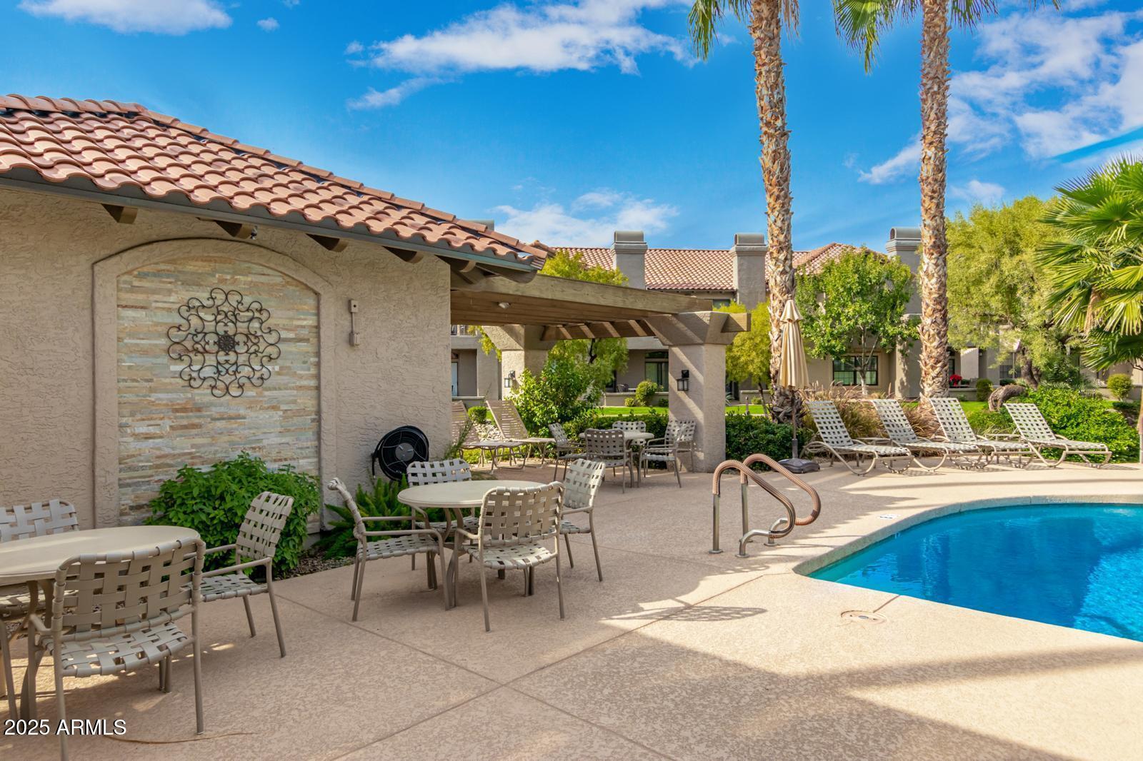 10015 East Mountain View Road, Unit 2017 Scottsdale, AZ 85258 - Photo 40 of 45 a view of a patio with table and chairs potted plants