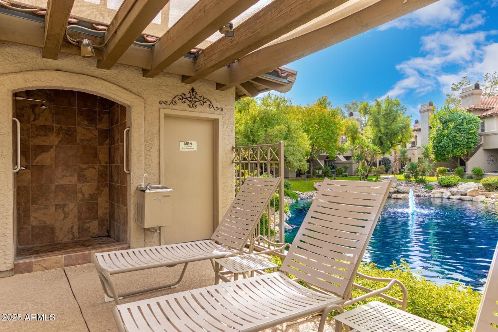 10015 East Mountain View Road, Unit 2017 Scottsdale, AZ 85258 - Photo 43 of 45 a view of a patio with a table and chairs with wooden floor and fence