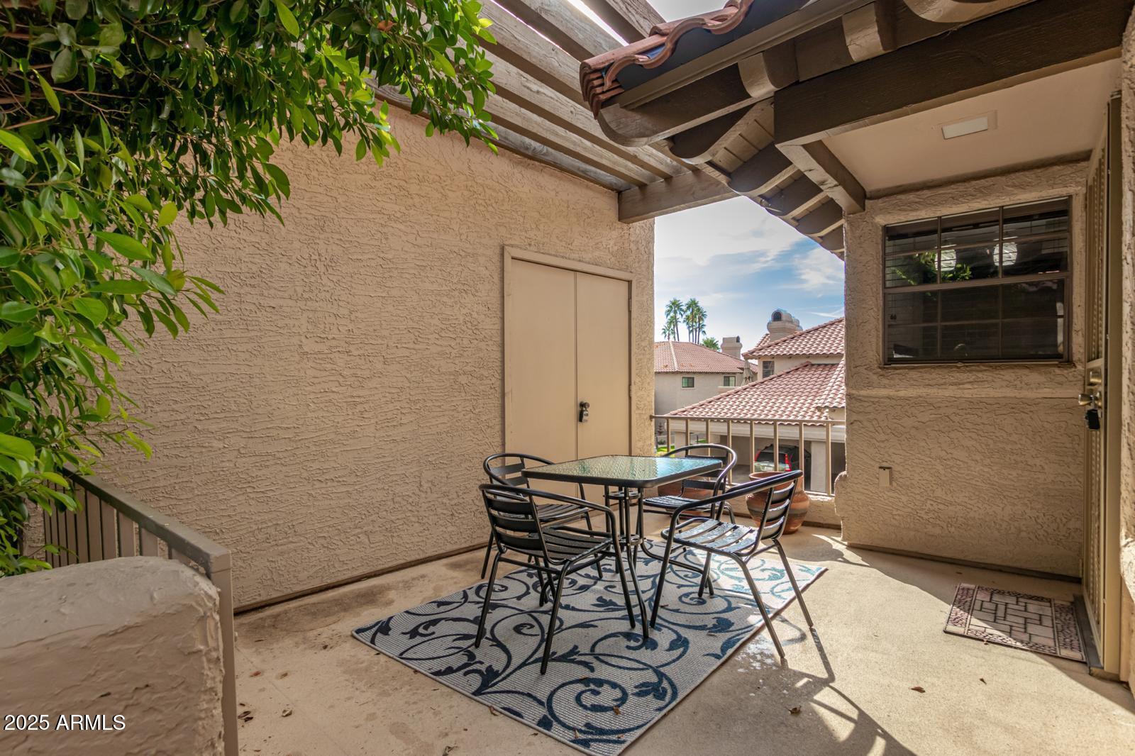 10015 East Mountain View Road, Unit 2017 Scottsdale, AZ 85258 - Photo 7 of 45 a view of a backyard with table and chairs with wooden floor and seating space