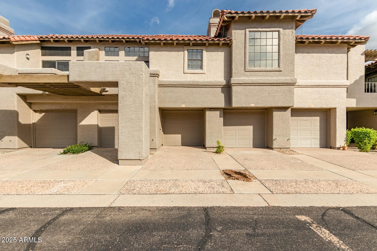 10015 East Mountain View Road, Unit 2017 Scottsdale, AZ 85258 - Photo 8 of 45 a front view of a house with a yard