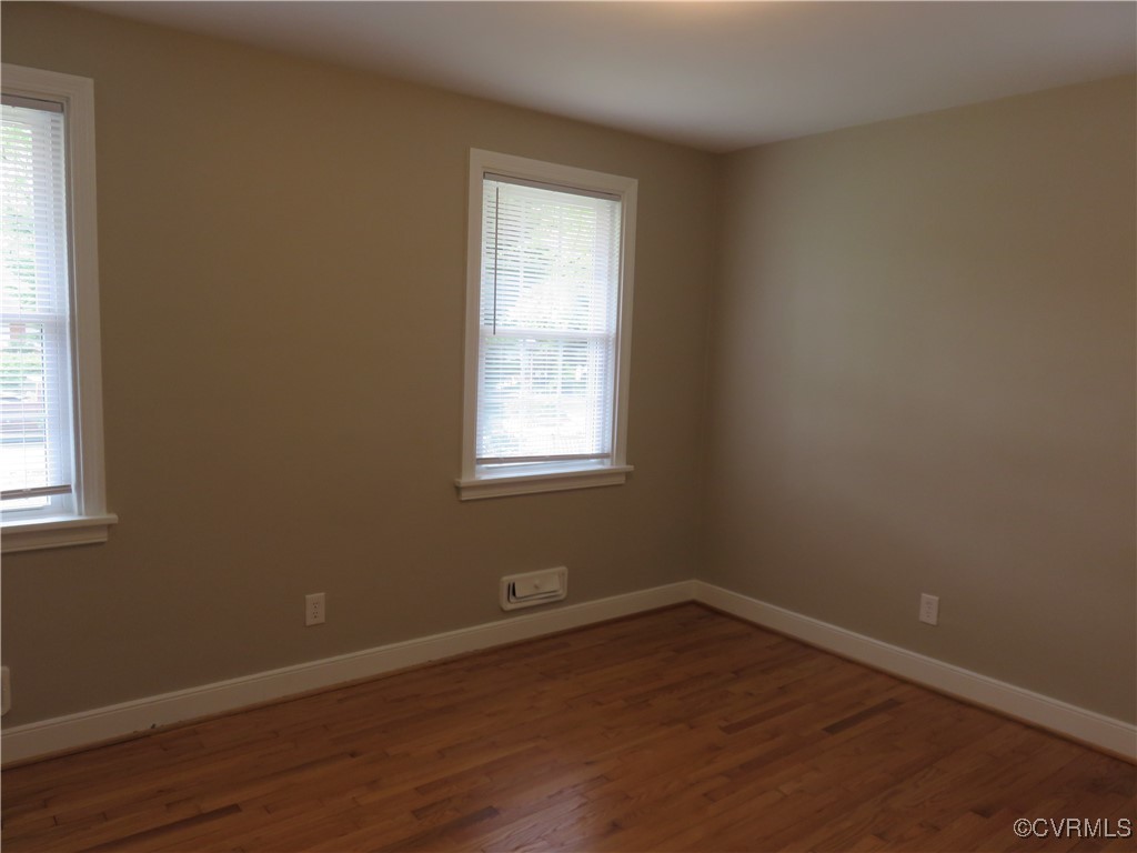 8708 Mapleton Road Henrico, VA 23229 - Photo 12 of 28 an empty room with wooden floor and windows