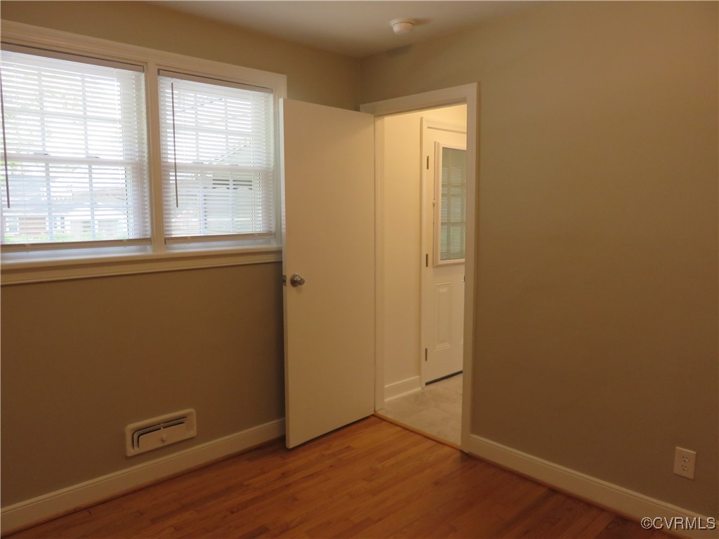 8708 Mapleton Road Henrico, VA 23229 - Photo 16 of 28 an empty room with wooden floor and a window