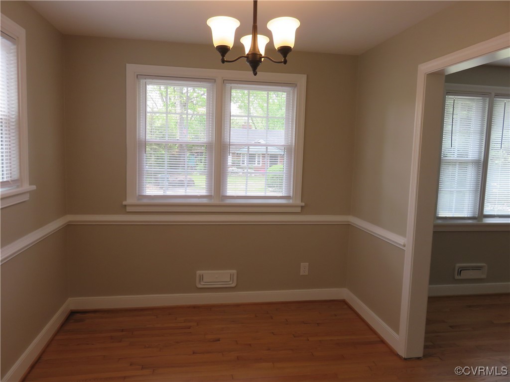 8708 Mapleton Road Henrico, VA 23229 - Photo 4 of 28 a view of an empty room with wooden floor and a window