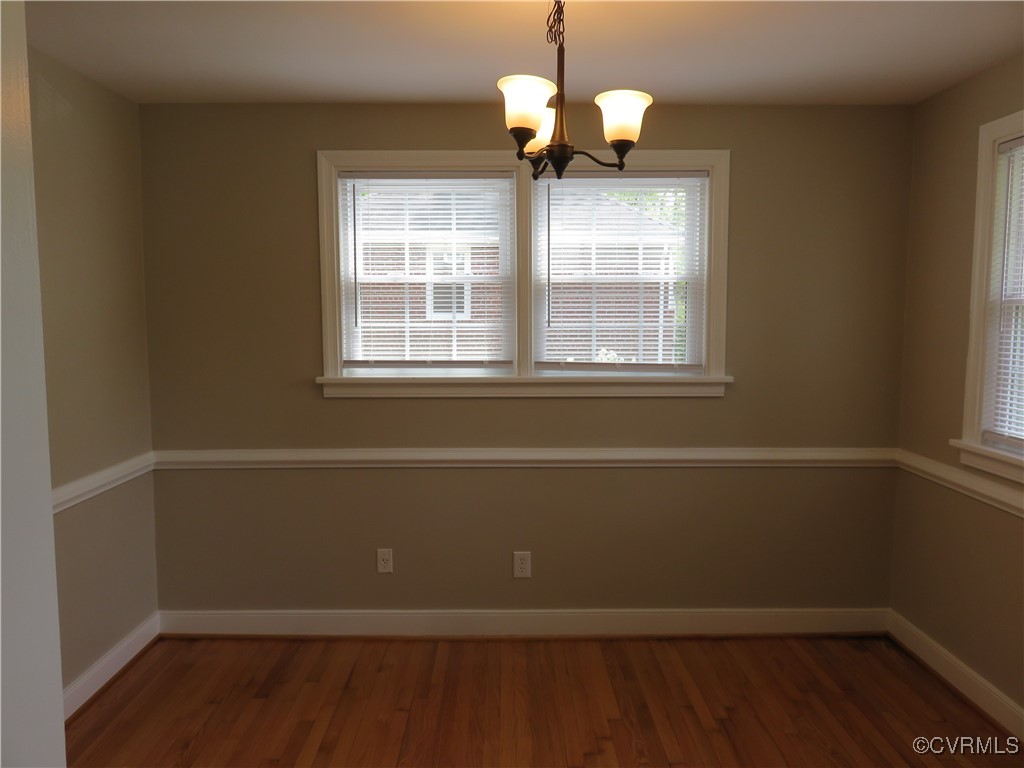 8708 Mapleton Road Henrico, VA 23229 - Photo 5 of 28 a view of an empty room with wooden floor and a window