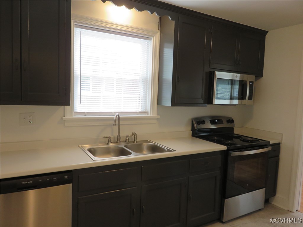 8708 Mapleton Road Henrico, VA 23229 - Photo 7 of 28 a kitchen with a sink stove and microwave