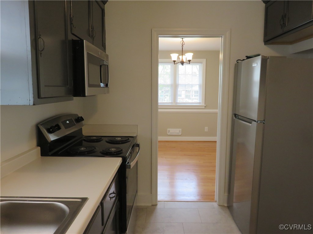 8708 Mapleton Road Henrico, VA 23229 - Photo 8 of 28 a kitchen with a refrigerator and a sink