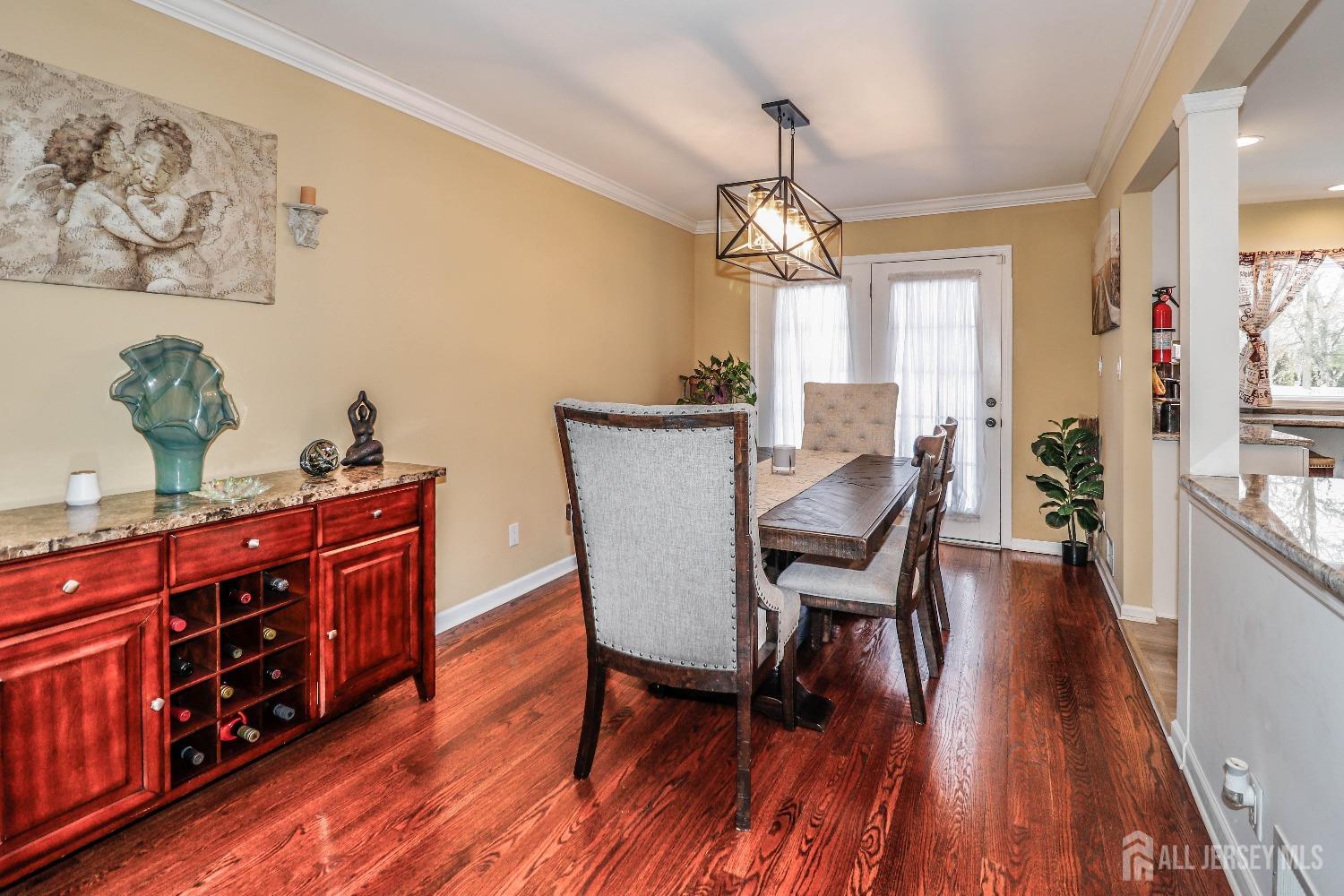161 Devon Road Colonia, NJ 07067 - Photo 11 of 34 a view of a dining room with furniture wooden floor and chandelier