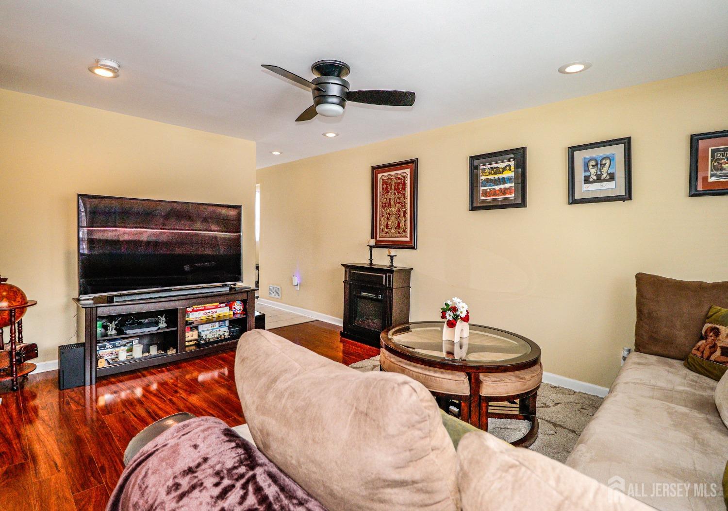 161 Devon Road Colonia, NJ 07067 - Photo 15 of 34 a living room with furniture and a flat screen tv