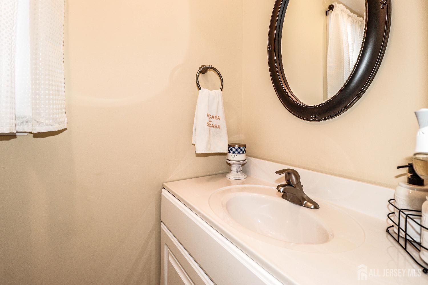 161 Devon Road Colonia, NJ 07067 - Photo 18 of 34 a bathroom with a sink and a mirror