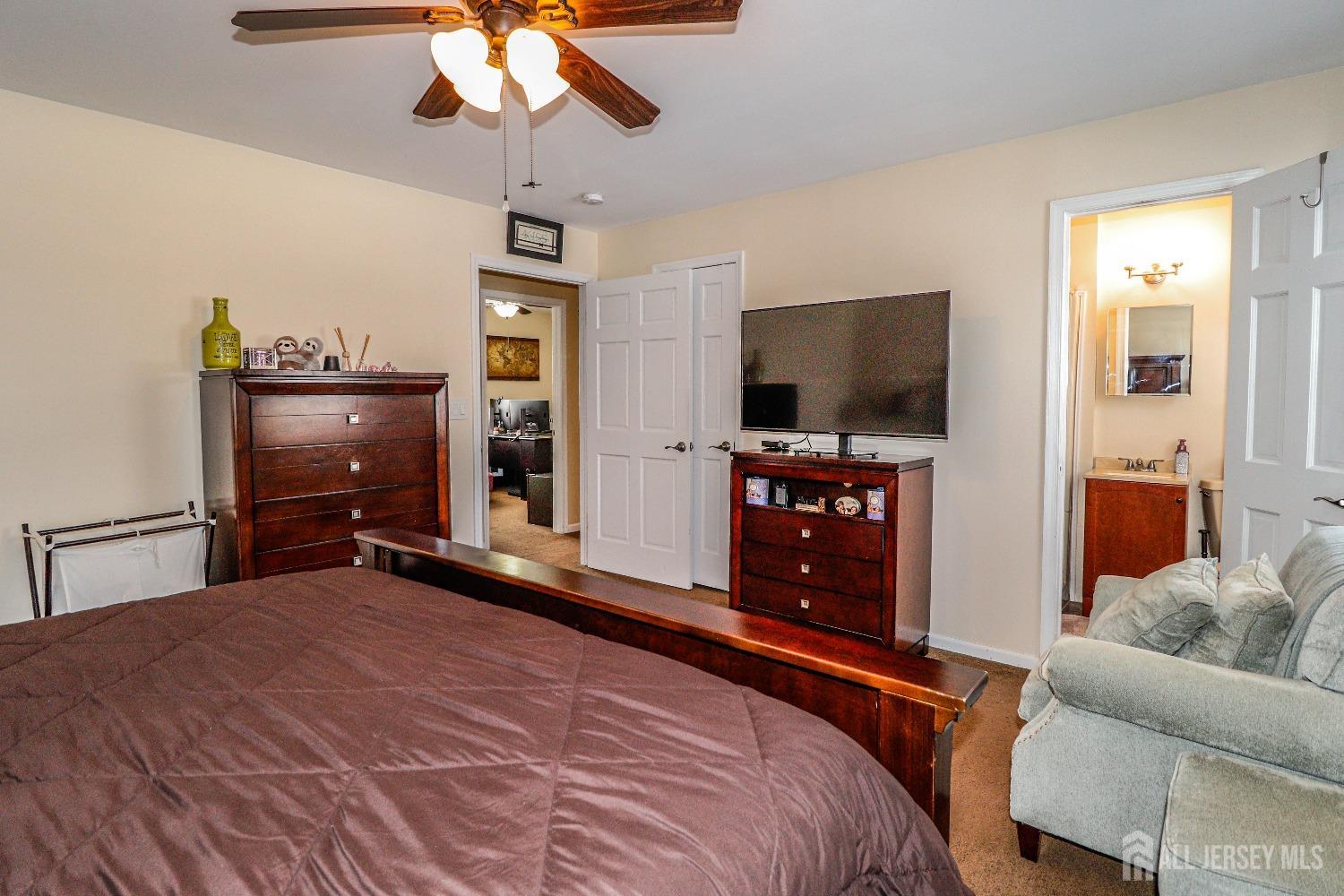 161 Devon Road Colonia, NJ 07067 - Photo 21 of 34 a bedroom with furniture and flat screen tv