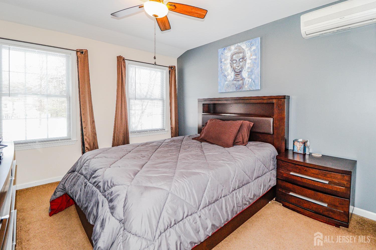 161 Devon Road Colonia, NJ 07067 - Photo 23 of 34 a bed sitting in a bedroom next to a window
