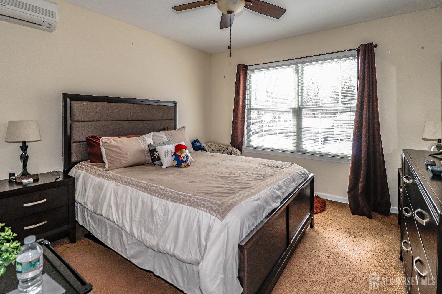 161 Devon Road Colonia, NJ 07067 - Photo 24 of 34 a bedroom with a bed and a flat tv screen on dresser