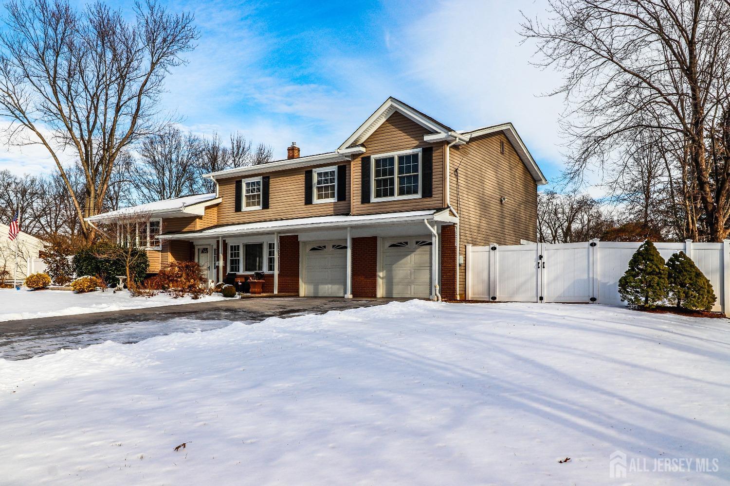 161 Devon Road Colonia, NJ 07067 - Photo 3 of 34 a front view of a house with a yard and garage