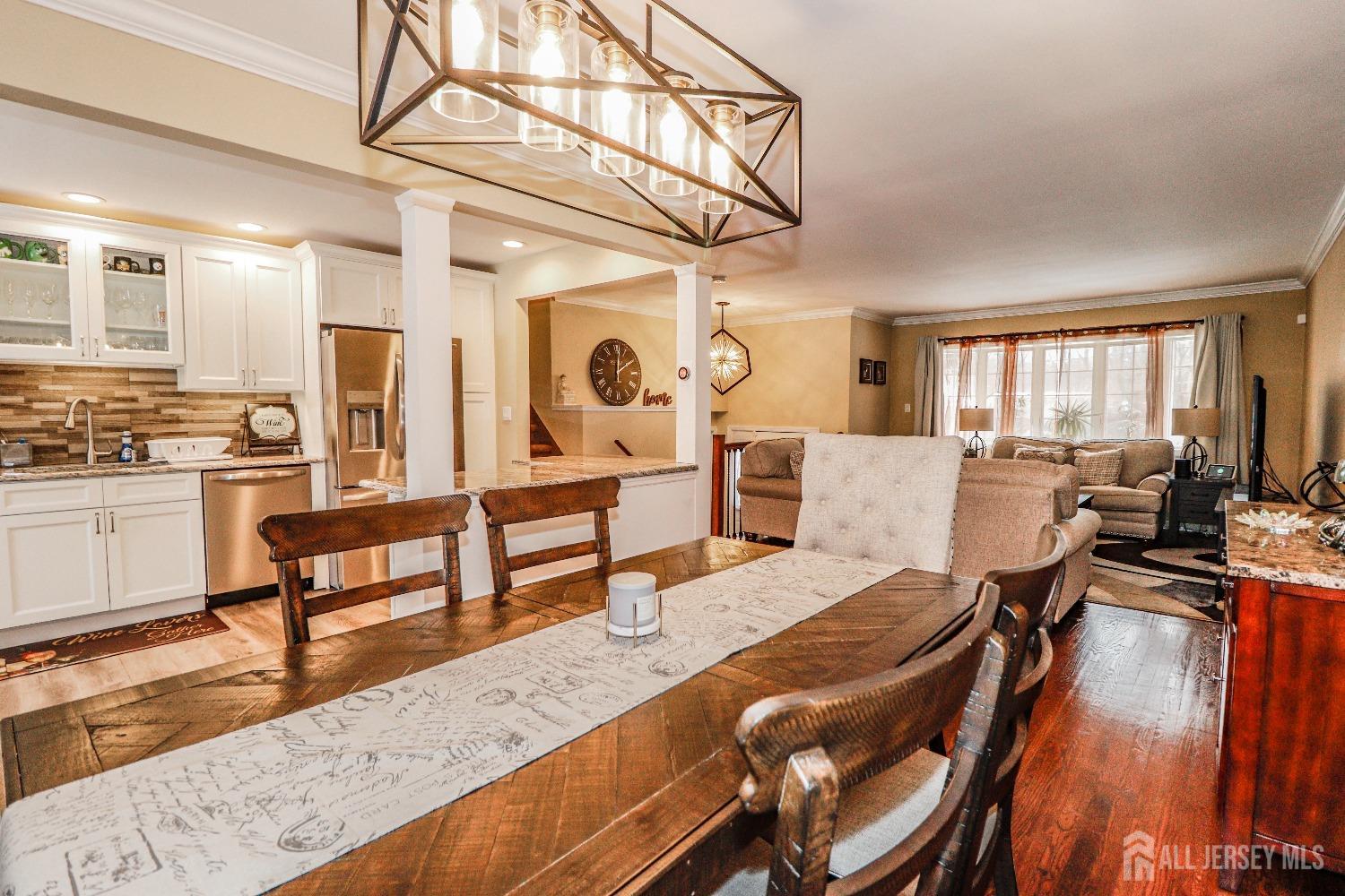 161 Devon Road Colonia, NJ 07067 - Photo 10 of 34 a living room with furniture a rug kitchen view and a large window
