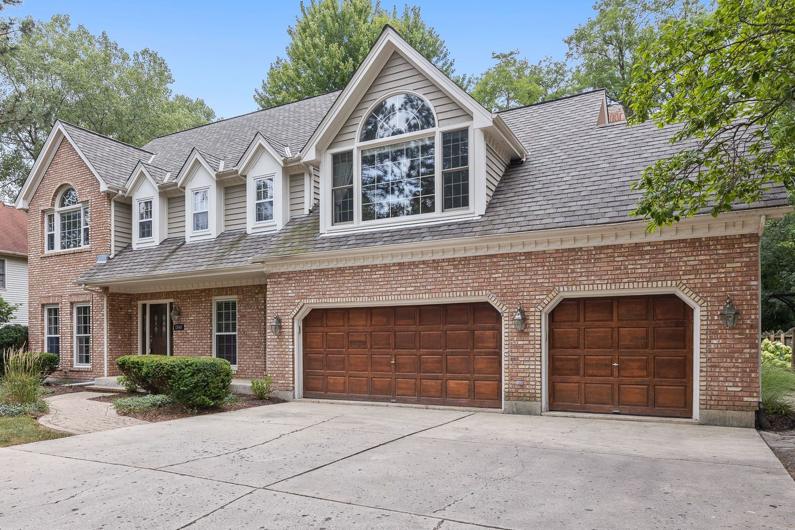 1540 West Wiesbrook Road Wheaton, IL 60189 - Photo 1 of 36 a front view of a house with yard and parking