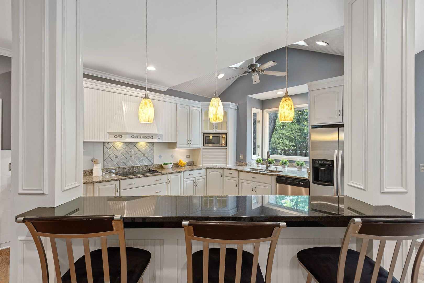 1540 West Wiesbrook Road Wheaton, IL 60189 - Photo 11 of 36 a kitchen with kitchen island granite countertop a sink and a stove top oven
