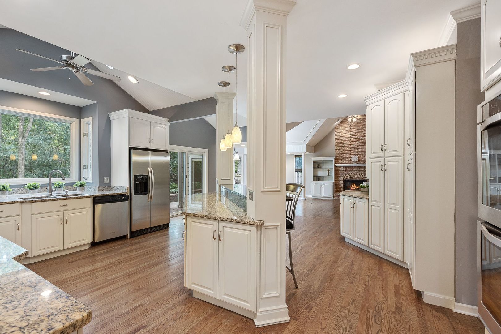 1540 West Wiesbrook Road Wheaton, IL 60189 - Photo 13 of 36 a kitchen with stainless steel appliances kitchen island granite countertop a refrigerator a sink a stove and white cabinets with wooden floor