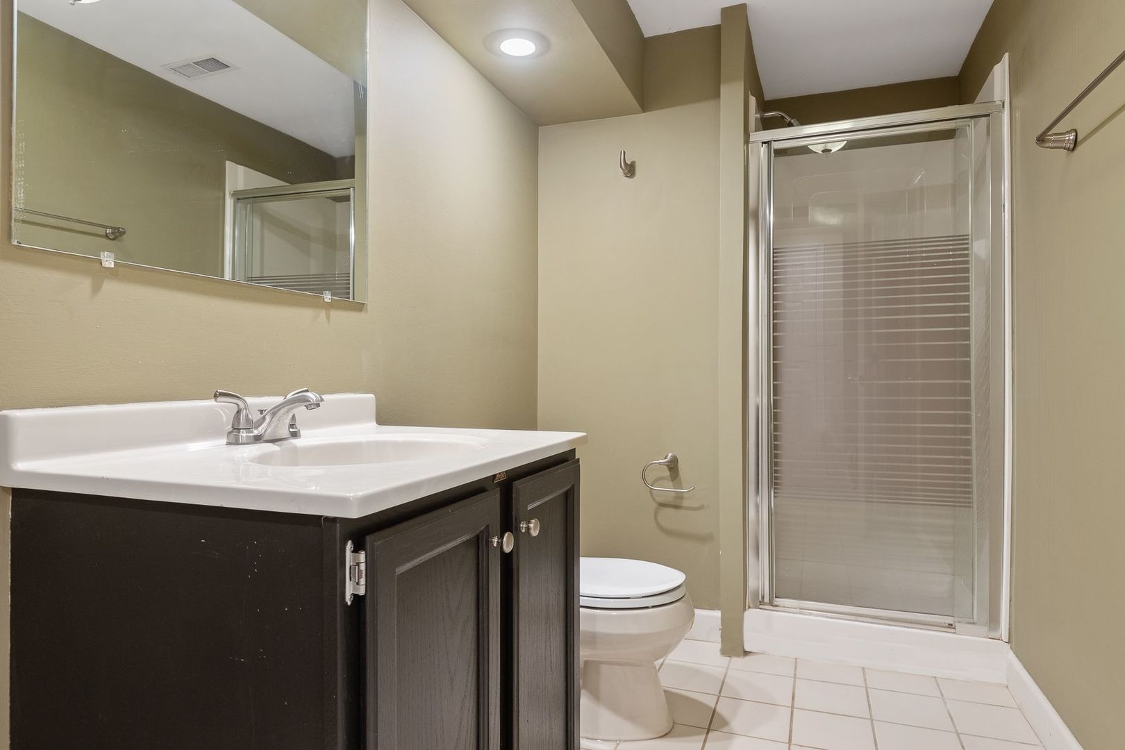 1540 West Wiesbrook Road Wheaton, IL 60189 - Photo 34 of 36 a bathroom with a sink a toilet and shower