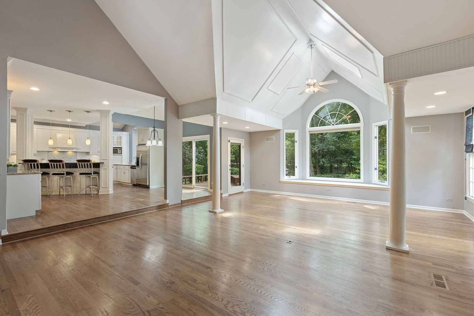 1540 West Wiesbrook Road Wheaton, IL 60189 - Photo 5 of 36 a view of a big room with wooden floor and windows