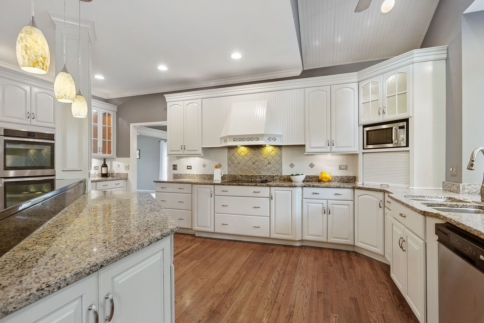 1540 West Wiesbrook Road Wheaton, IL 60189 - Photo 9 of 36 a kitchen with stainless steel appliances granite countertop a stove a sink and white cabinets