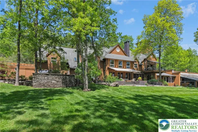 a front view of house with yard and green space