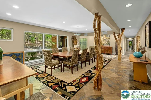 a bedroom with a bed couch and windows