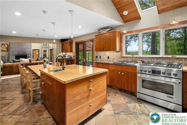 a dining room with furniture and a floor to ceiling window