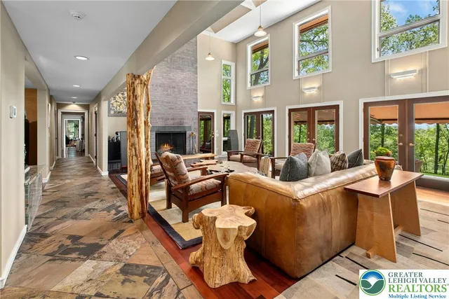 a living room with furniture fireplace and a table