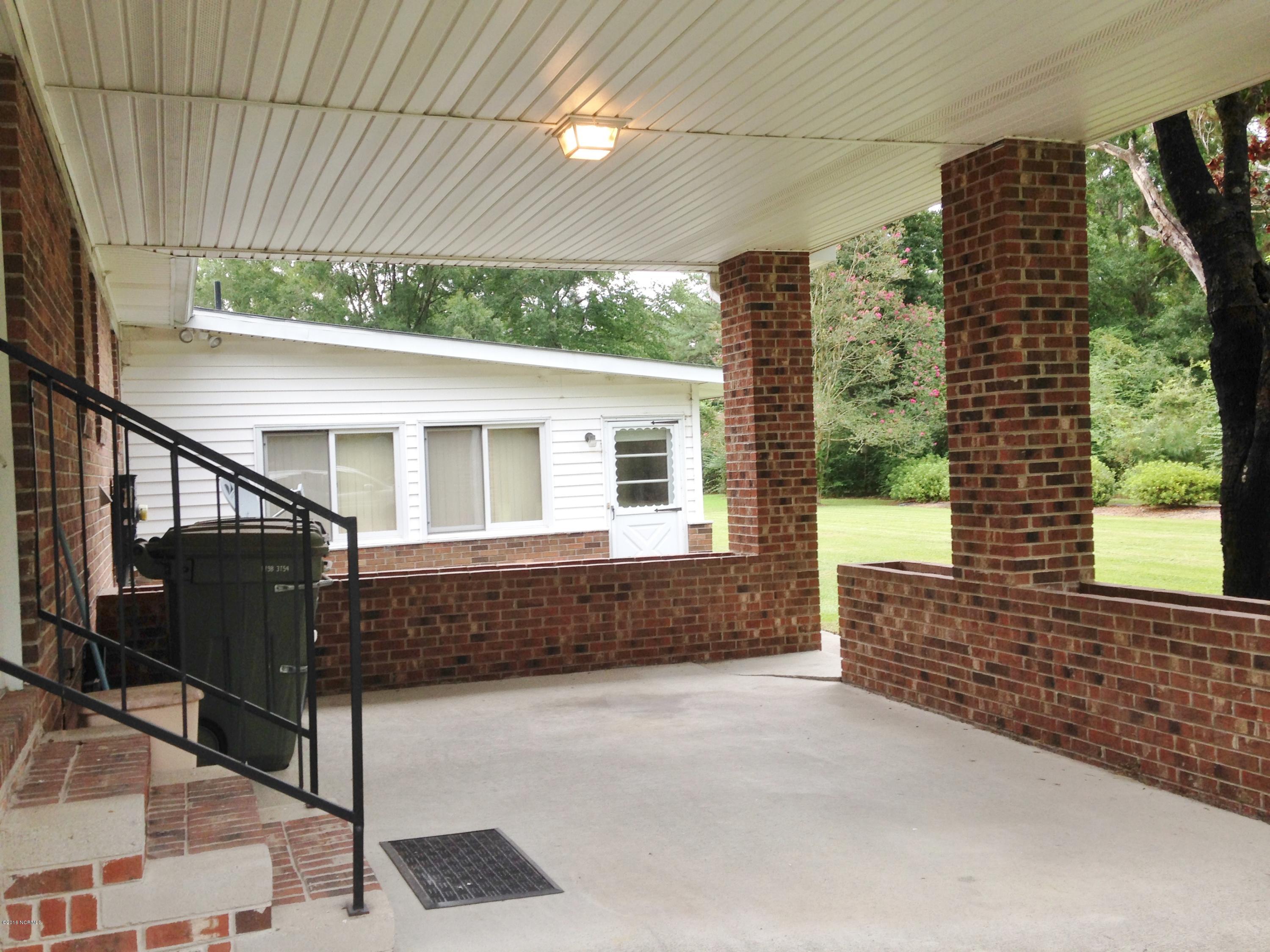 213 Lawson Road Washington, NC 27889 - Photo 34 of 39 PLANTERS SURROUND THIS CARPORT THAT COULD ALSO BE USED FOR A PATIO.