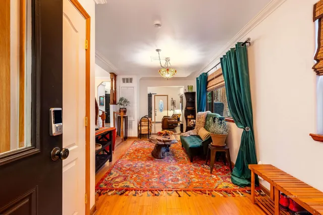 a large white kitchen with lots of counter top space and stainless steel appliances
