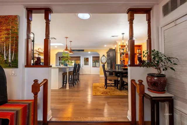 a living room with furniture and large windows