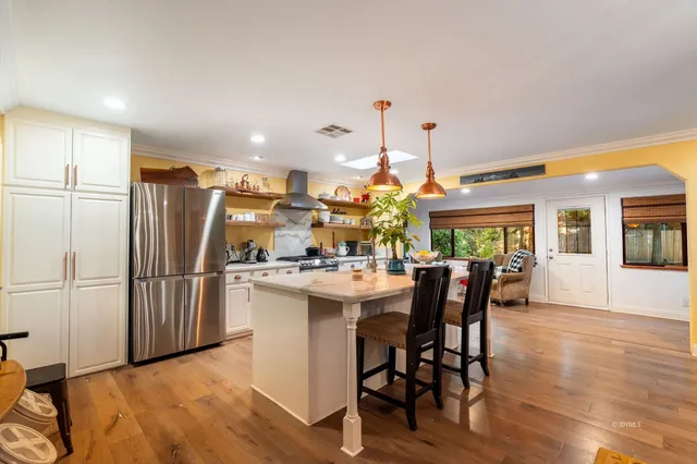 a dining table chairs and a chandelier