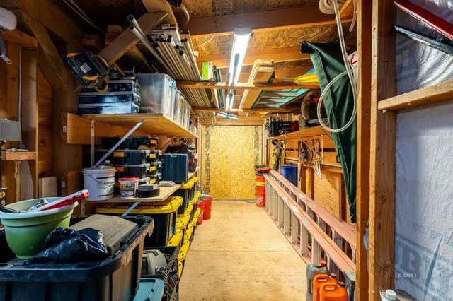 a view of backyard of house with outdoor seating and trees
