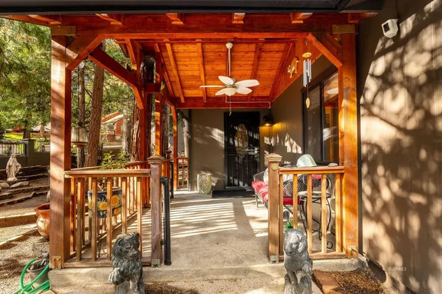 a view of a dining room with furniture a chandelier and wooden floor